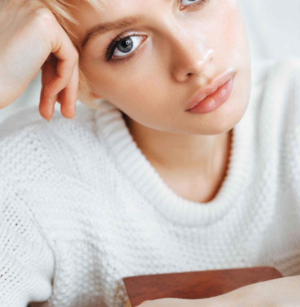 blonde-young-woman-wearing-sweater-PVSQXYK-scaled.jpg